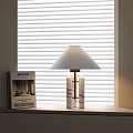 Modern Table Lamp with Double Column Base and White Lampshade Near Window Blinds and Book