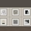 Framed Black And White Abstract Artworks On Light Colored Wall With Wooden Floor