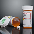 Open Pill Bottle With Spilled Tablets And Label On Black Surface 3d model