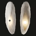 Two White Fluffy Chandeliers With Black Small Dot on Left and Lit on Right