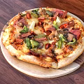 Freshly Baked Pizza Topped With Assorted Vegetables Meats And Creamy Melted Cheese