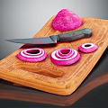 Wooden Cutting Board With Sharp Knife And Fresh Purple Onion Sliced Rings