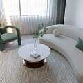 Modern Living Dining Room With Beige Curved Sofa Green Pillow Round Coffee Table And Dining Chairs