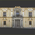 Yellow Classical Building With Decorative Facade Symmetrical Windows Ornate Main Door And Stone Architectural Details