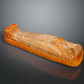 Ancient Egyptian Sarcophagus Sculpture Carving With Orange Stone Face And Wing Patterns