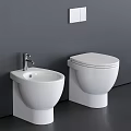 Modern White Toilet With Adjacent Washbasin Against Grey Wall And Dark Floor
