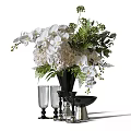 Decorative Ornament Set Featuring White Orchids Hydrangeas Ferns Black Vase Glass Goblets And Silver Bowl