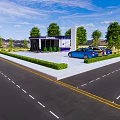 Modern Glass Building In Landscaped Garden With Green Hedge Lawn And City Road