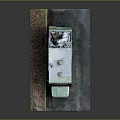 Green Vintage RV With Roof Equipment Parked On Gravel And Paved Area