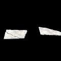 White Broken Fragments With Cracks Lying On Black Background Surface