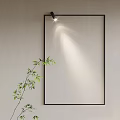 Modern Wall Lamp Lighting Above Black Frame With Green Bamboo On White Wall