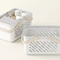 Two White Storage Baskets With Beige Handles And Hollowed Out Design