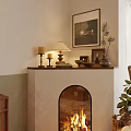 Cozy Fireplace With Burning Fire Mantel Candles Lamp Framed Art And Green Plants