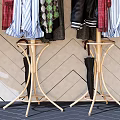 Stylish Clothes Hangers With Hanging Clothes Bags And Hats Against Geometric Patterned Wall