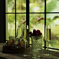 Drinks on Tray with Glasses Bottles Champagne Cups Red Fruits and Window Background