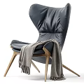 Comfortable Black Leather Leisure Chair With Wooden Legs And Gray Throw Blanket