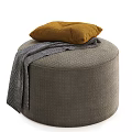 Gray Upholstered Round Ottoman Bench With Yellow Cushion And Gray Knit Blanket