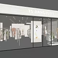 Fashion Clothing Store Glass Facade With Interior Displays Mannequins And Soft Lighting