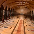 Indoor Arched Corridor With Row Of Arches And Geometric Pattern Floor Tiles