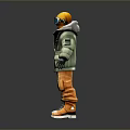 Man wearing green jacket orange pants yellow helmet goggles and backpack standing on gray background