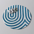 Blue And White Wavy Striped Round Rug With Open Magazine And Green Plant