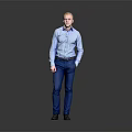 Man In Blue Shirt And Blue Pants Standing With Hands In Pockets Against Gray Background