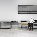 Modern Stainless Steel Kitchen Appliances And Cabinets With Workstation Counter Chef Preparing