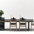 Modern Dark Dining Table Set With Light Wooden Chairs Wine Glasses Plates And Green Plant