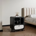 Modern Double Bed With Beige Upholstered Headboard And Black Nightstand With Books And Dried Flowers