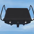 Portable Black Device With Handle Grid Surface Circular Knobs And Blue Sky Background