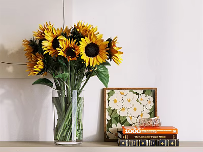 Transparent Glass Vase With Sunflowers And Green Leaves Near Decorative Painting And Books 3d model