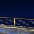 Modern Public Facility Corridor Featuring Metal Cable Railings And Tile Flooring
