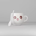 White Cup With Cute Cartoon Smiling Face And White Spoon Beside Simple Gray Background