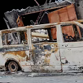 Burned Charred Van Wreckage In Fire Damaged Building Debris Scene