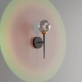 Modern Wall Light With Transparent Spherical Shade Black Base Gold Accent And Soft Lighting Effect