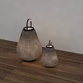 Two Woven Table Lamps in Different Sizes on Wooden Floor with White Wall
