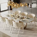 Elegant Restaurant Dining Space With Round Table White Chairs Golden Chandelier And Floral Decor