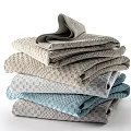 Soft Textured Towels Stacked With Light Gray And Blue Woven Patterns