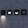 Black Square Wall Lighting Fixtures With Various Designs And Illuminated Unit On Dark Wall
