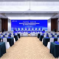 Spacious Conference Hall With Rows Of Seats Stage Blue Screens And Banners