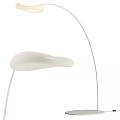 Modern Floor Lamp With White Curved Shade And Sleek Metal Stand Design