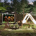 Scenic Campsite Featuring Tent Trees Campfire String Lights And People Enjoying Outdoor Evening