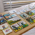 Colorful Children's Books with Various Covers Featuring Dinosaurs and Animals for Display on Wooden Table