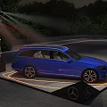 Blue Mercedes-Benz Car on Illuminated Display Platform With Stage Lights And Background Trees
