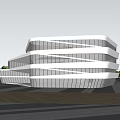 Modern Cultural Center Building With Sleek Glass Facade Surrounded By Green Lawn And Trees