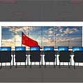 Monitoring Room With Large Screen Wall Multiple Computer Monitors And Rows Of Chairs