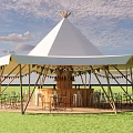 Outdoor Conical Top Tent Bar With String Lights And Wooden Tables Chairs