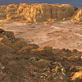 Rugged Desert Scenery With Golden Rock Formations And Sunset Illuminated Valleys