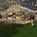 Vibrant Commercial Street with Tents String Lights and Green Grass at Free Camp