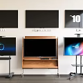 Multiple Televisions Mounted on Wall and Stands with Black and Lit Screens Displaying